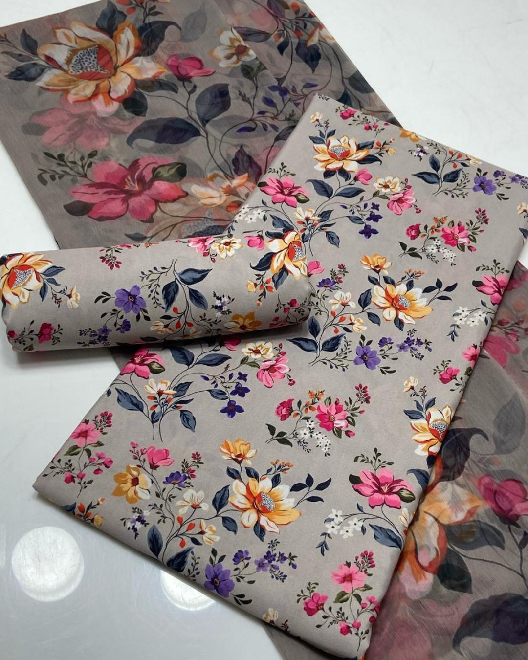 Floral-patterned fabric swatches on a gray background