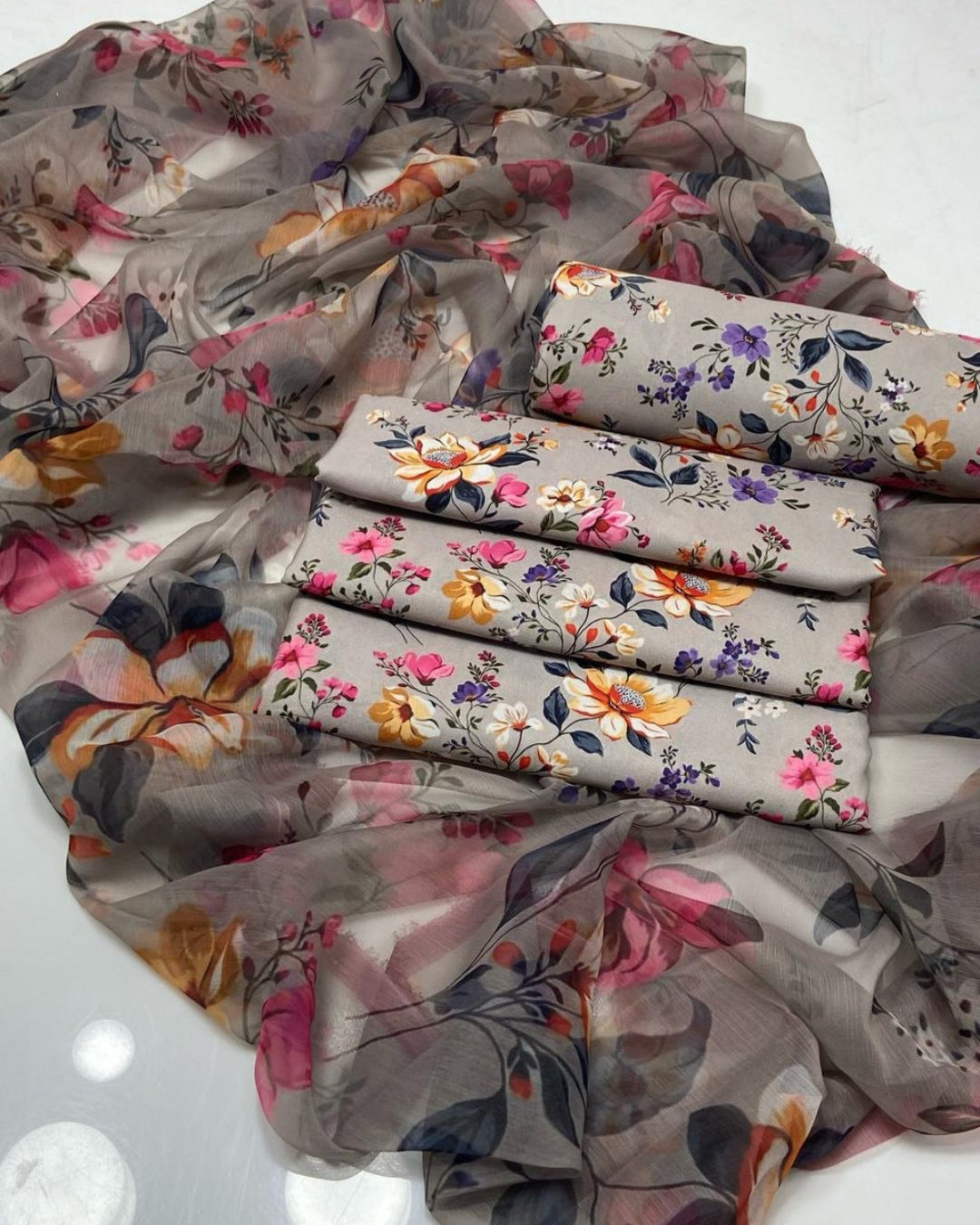 Floral-patterned fabric with rolled-up sections on a white background