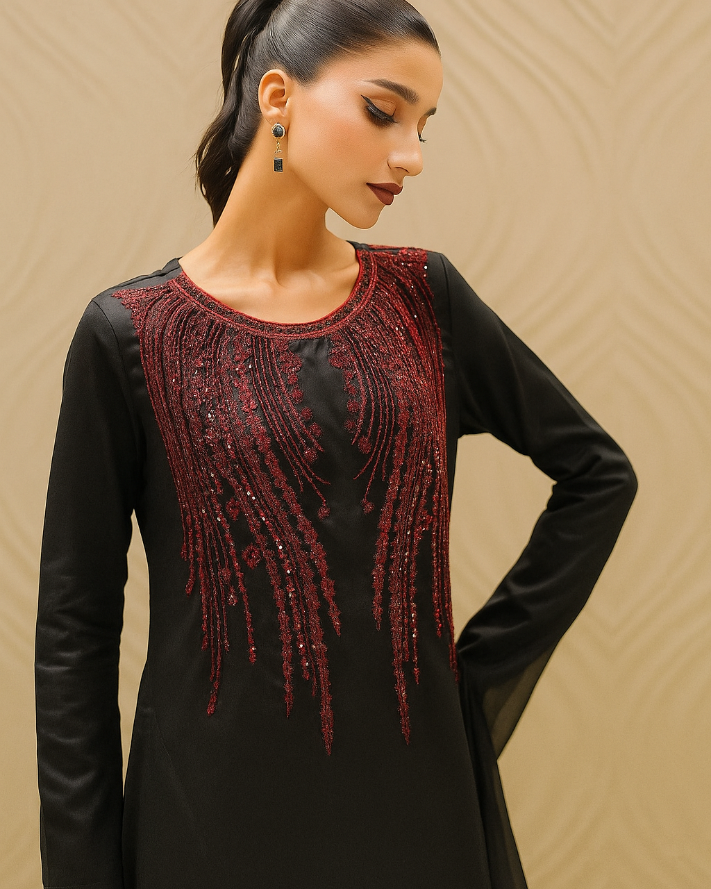 Woman wearing a black dress with red beaded details against a beige background
